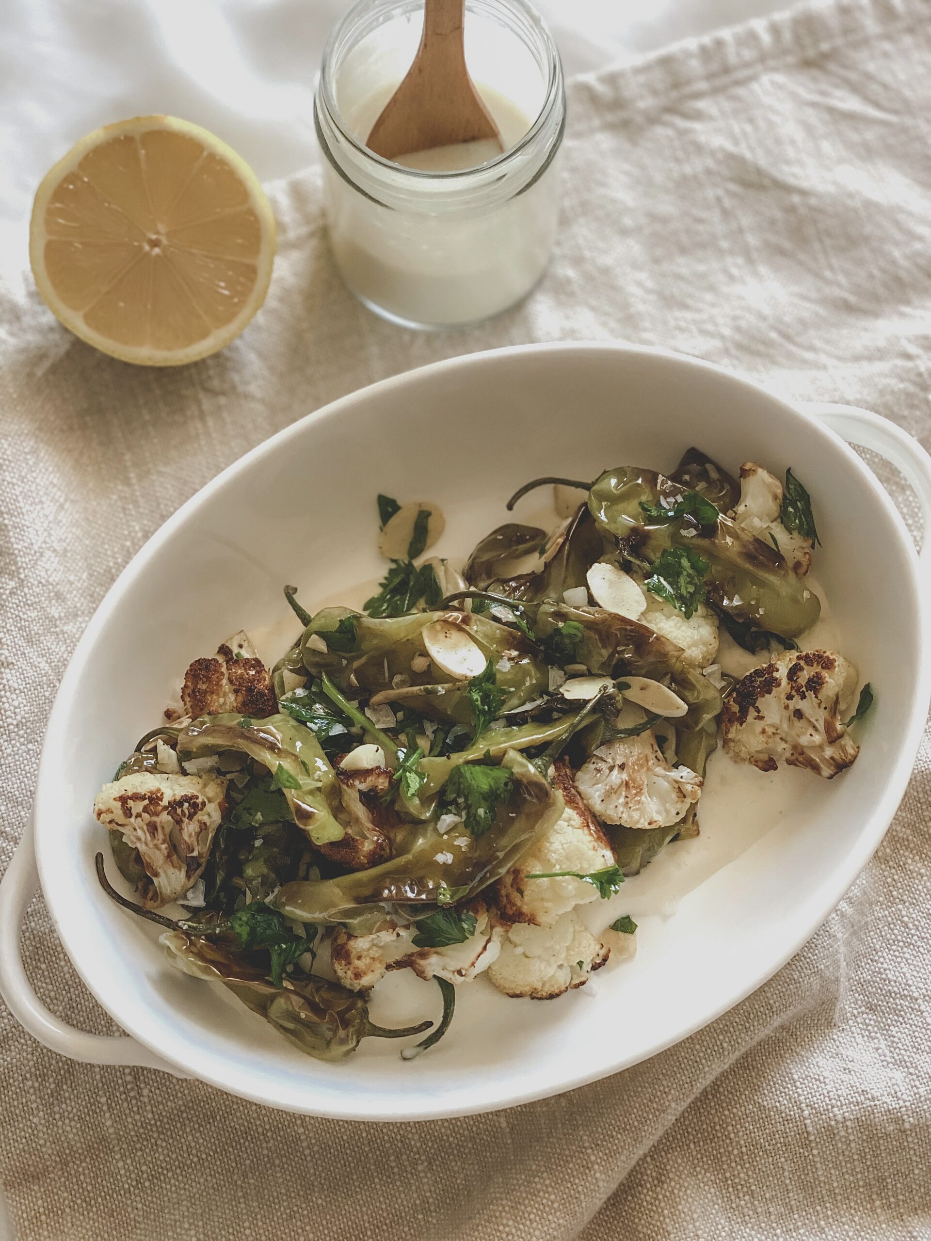 Roasted Cauliflower and Shishito Peppers with Creamy Garlic Sauce